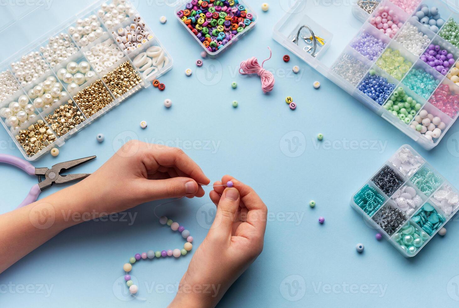 Creating colorful beaded jewelry with vibrant materials on a crafting table photo