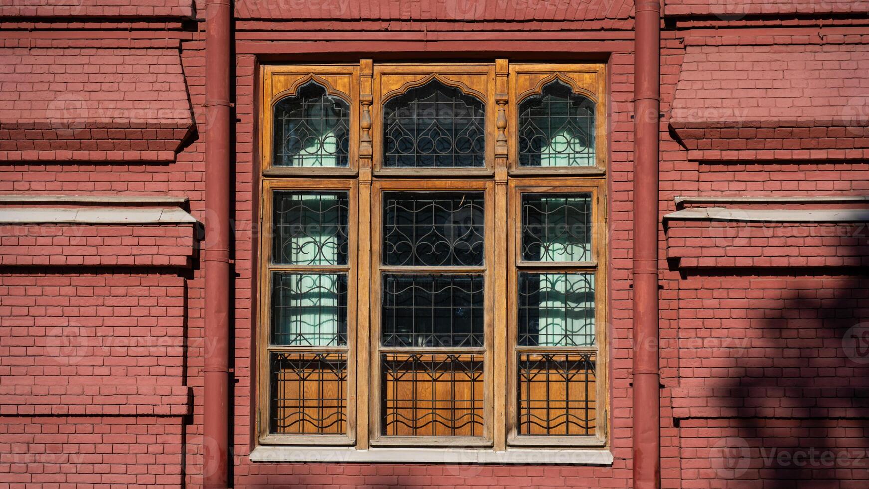 A large, wooden, old window of an old, red-brick building in Moscow photo