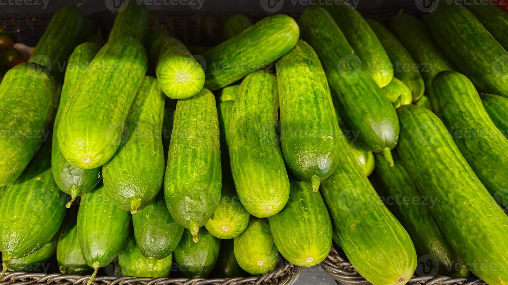 Cucumbers background. Cucumbers on store shelves. Vegetables in the store photo