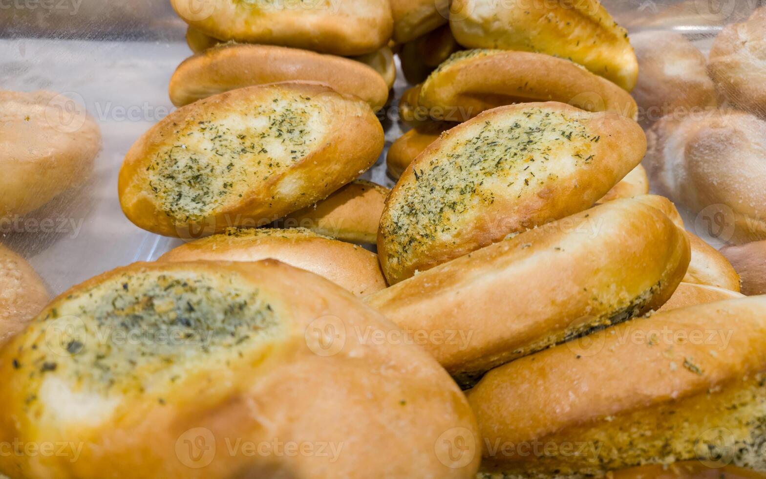 Buns with cheese and dill on the counter in the store. Bakery products on sale photo