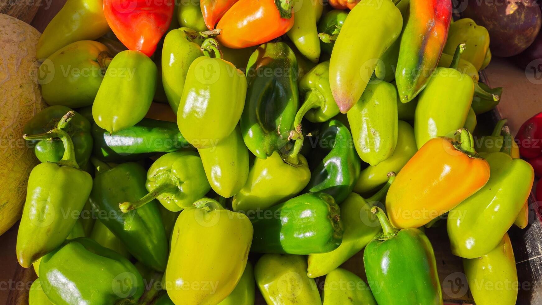 Green and yellow peppers are on the counter at the market. Vegetables photo