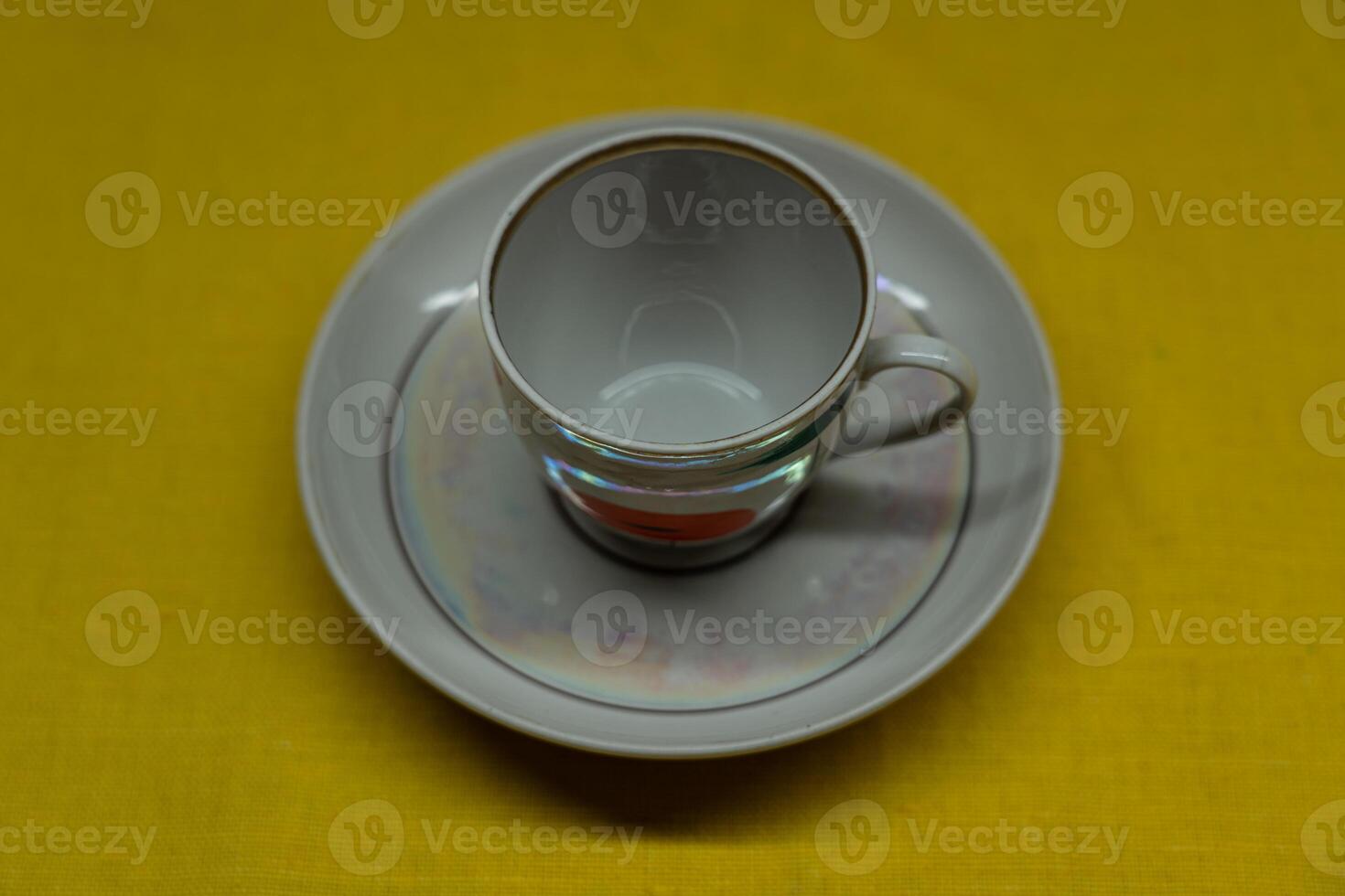 A cup in a saucer on a yellow background, top view. A coffee mug. Espresso Mug photo