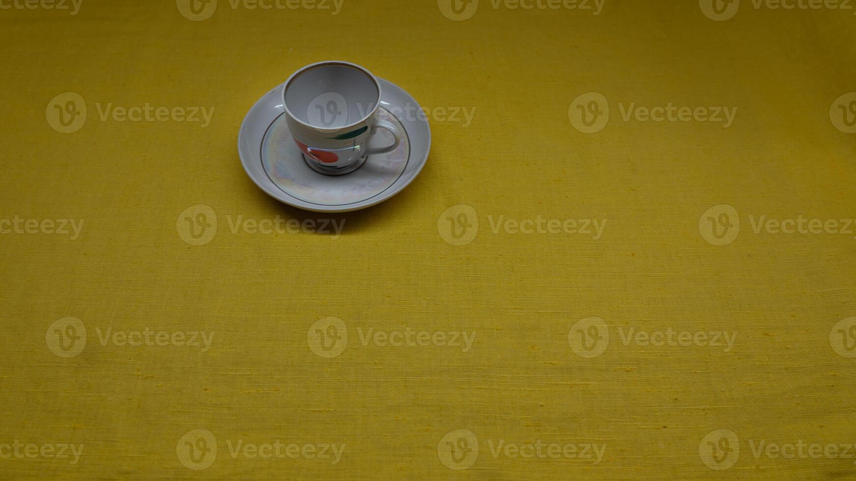 A cup in a saucer on a yellow background, top view. A coffee mug. Espresso Mug photo