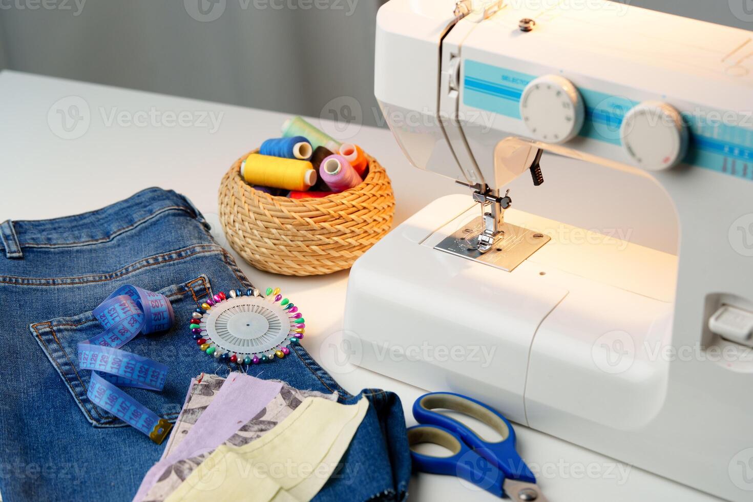 Sewing machine in use on a wooden table, stitching a light fabric in a well-lit indoor workspace photo