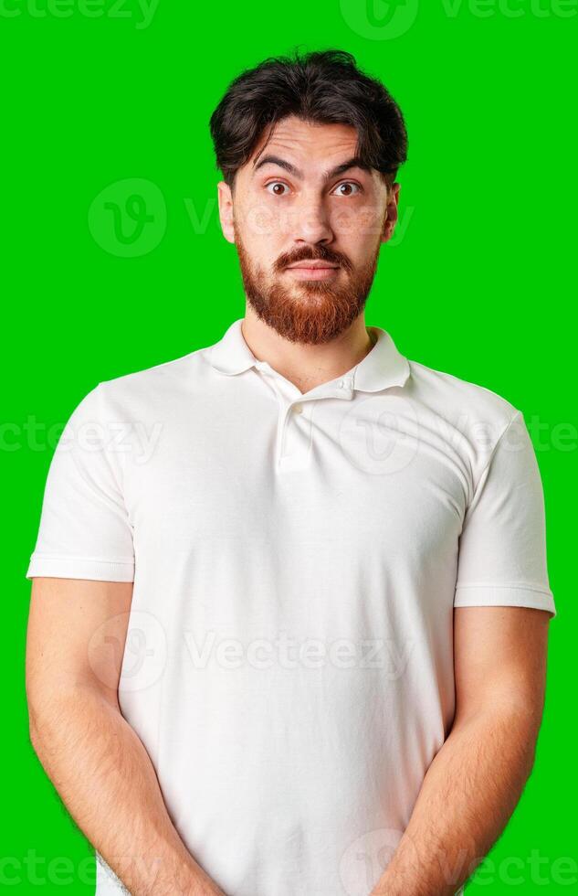 A man with a serious expression stands against a vibrant green background photo