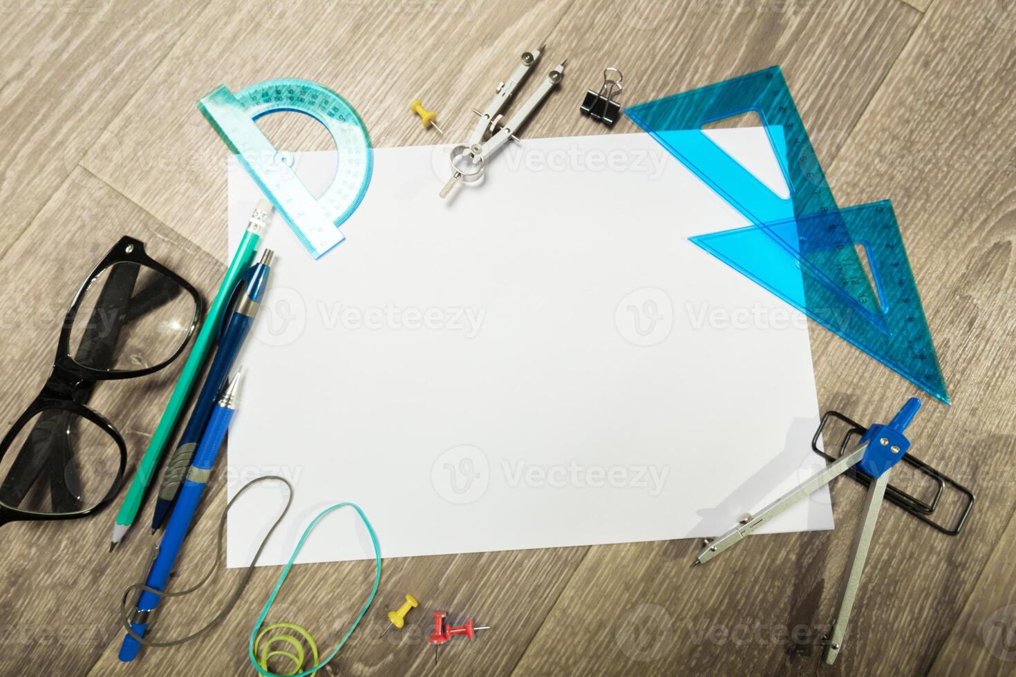 Blank notebook and pencil with glasses on wooden table photo