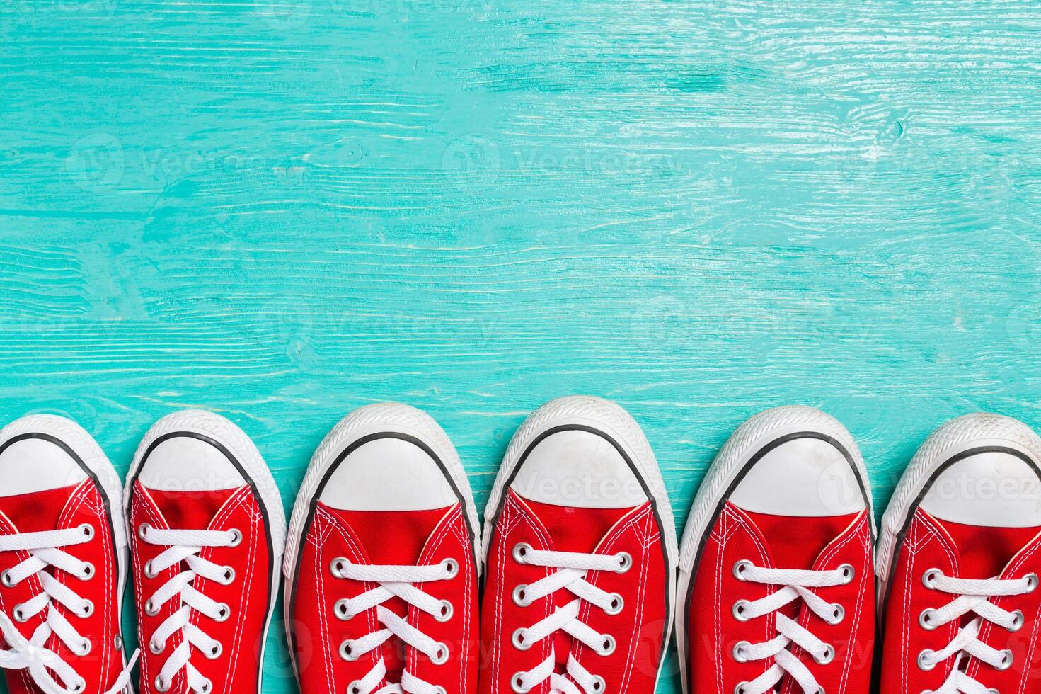 red sneakers on wooden background. photo