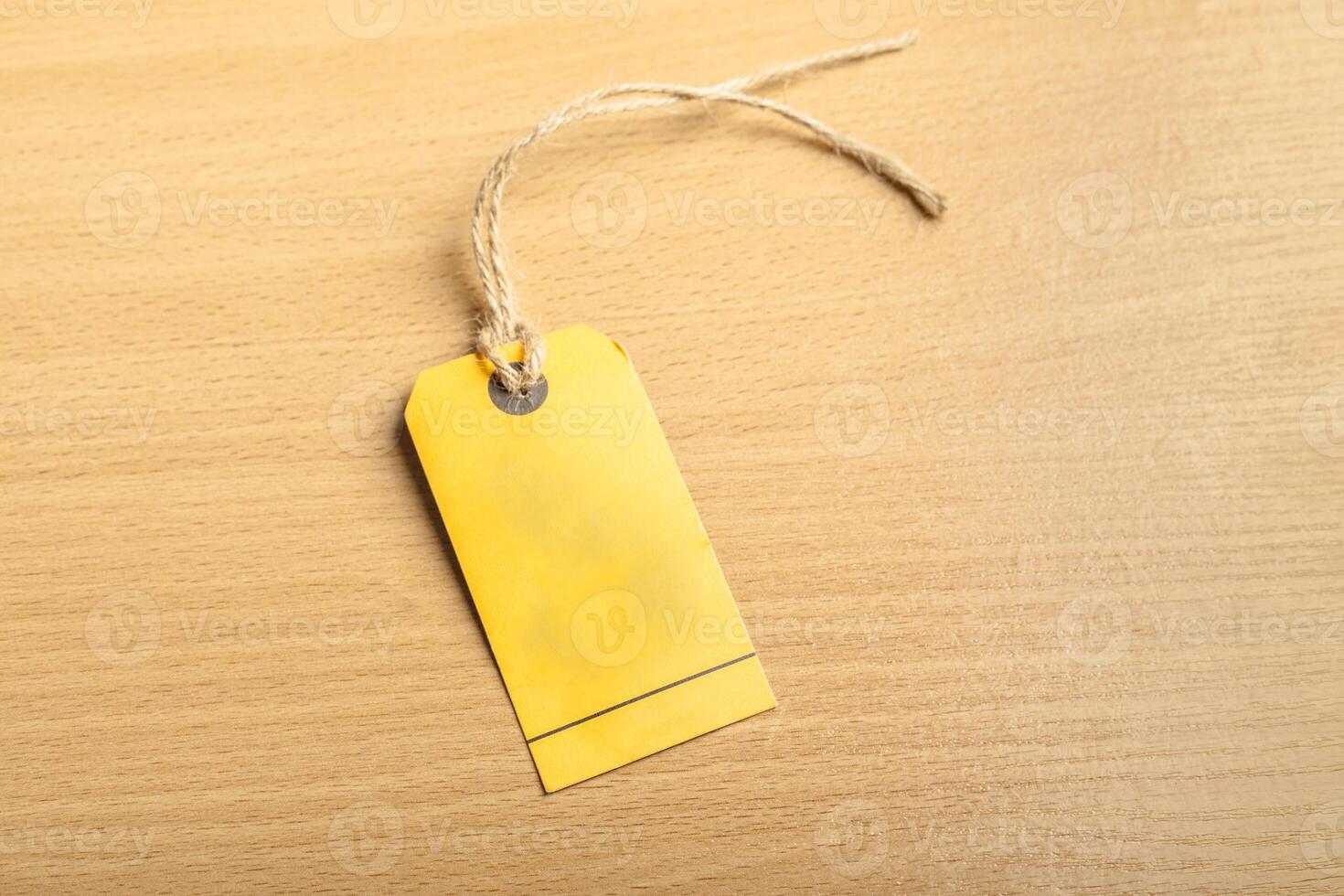 Blank tag on wooden background photo
