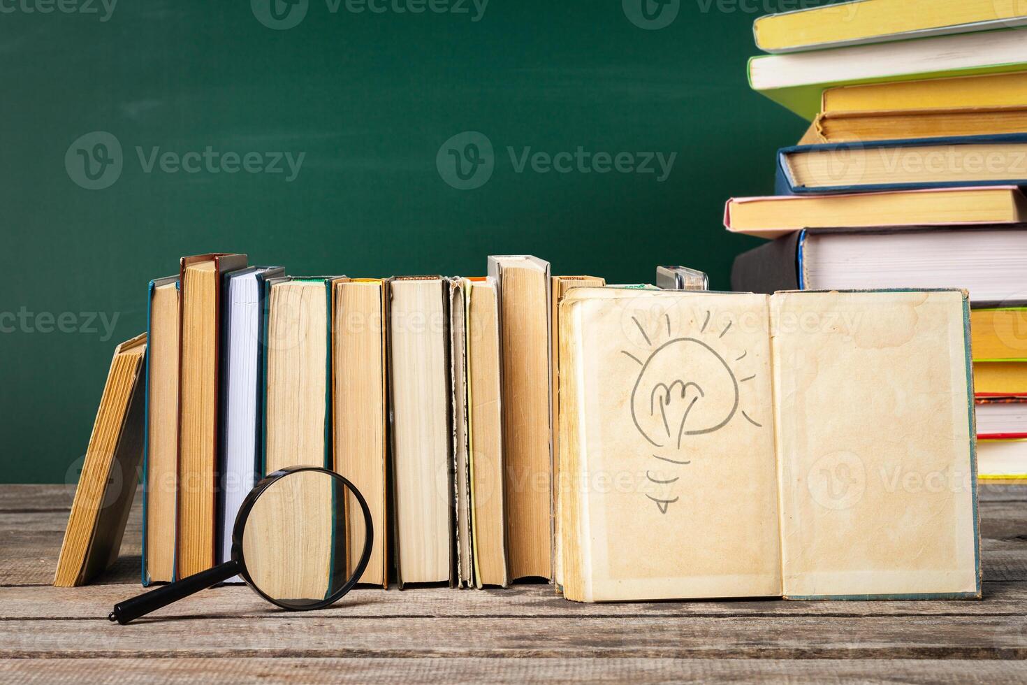 School blackboard with pile of books photo