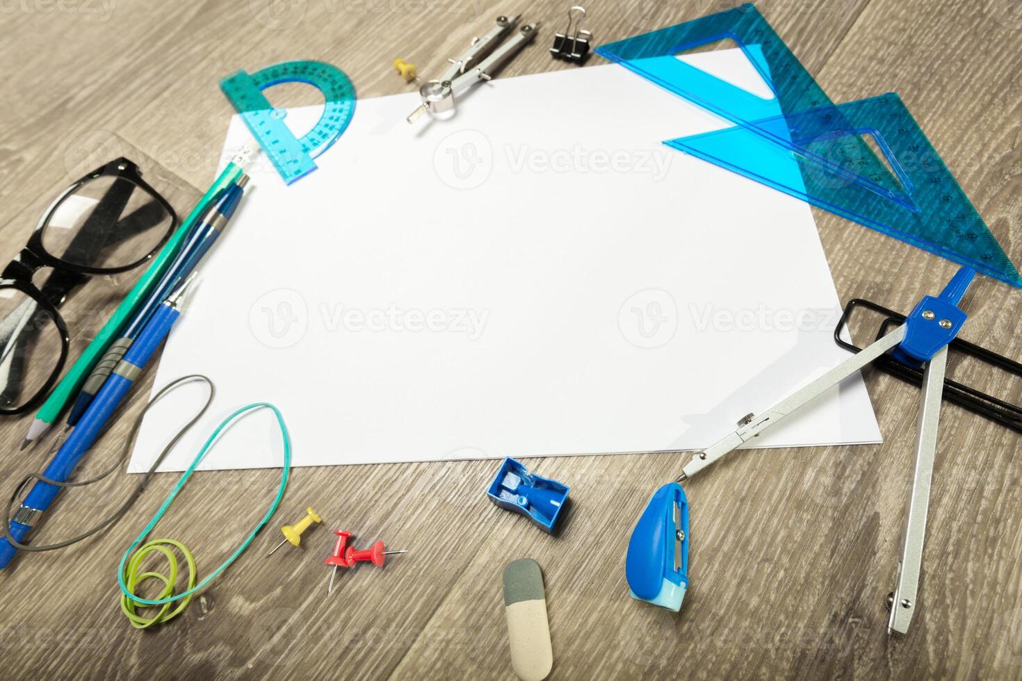 Blank notebook and pencil with glasses on wooden table photo