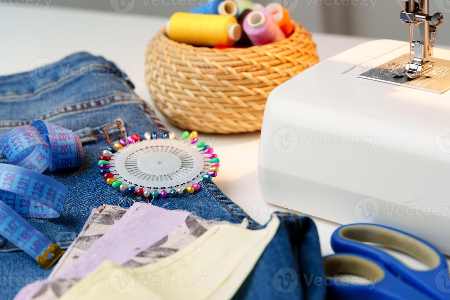 Sewing machine in use on a wooden table, stitching a light fabric in a well-lit indoor workspace photo