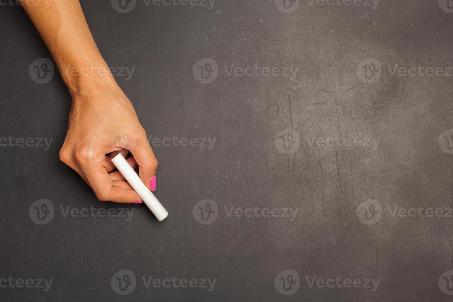 Hand holding chalk piece photo