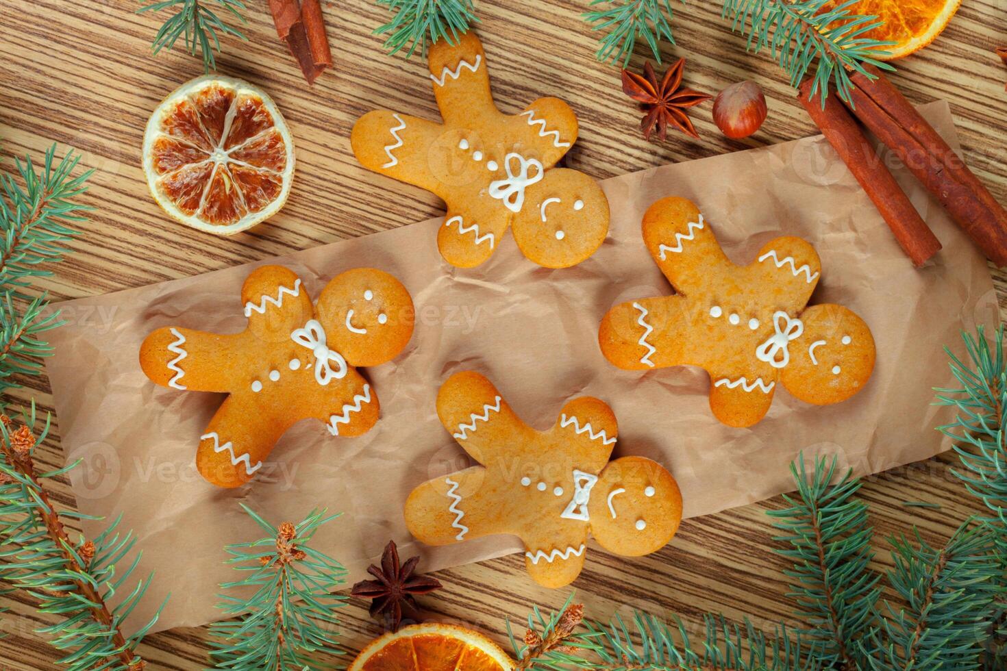 Christmas background with branch of fir tree decorated by gingerbread. photo