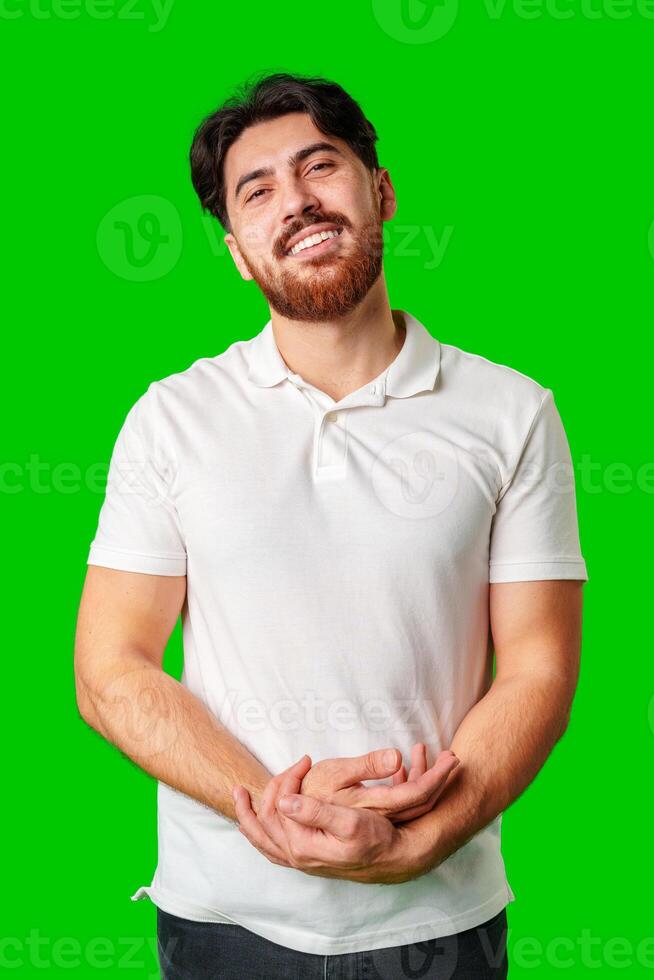 A man with a beard smiles confidently against a bright green background photo