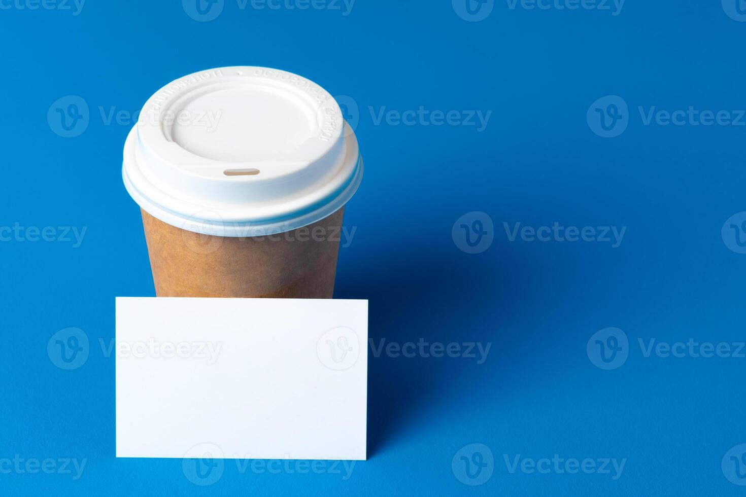 Blank takeaway coffee cup and white businesscards photo