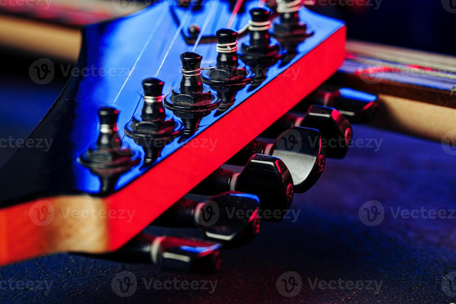 Guitar headstock with tuners on dark background photo