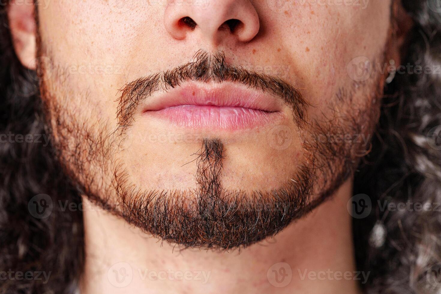 young man showcasing a unique beard style and lips photo