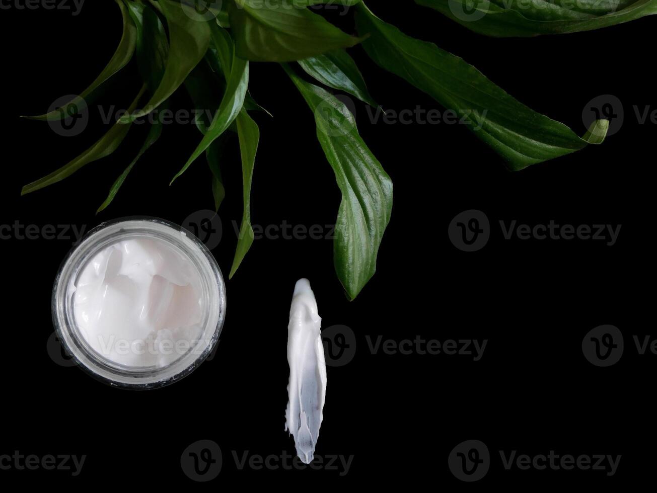 Natural organic face cream isolated on black with copy space. Cosmetics based on natural ingredients without preservatives. Concept of self-care and caring for the environment photo