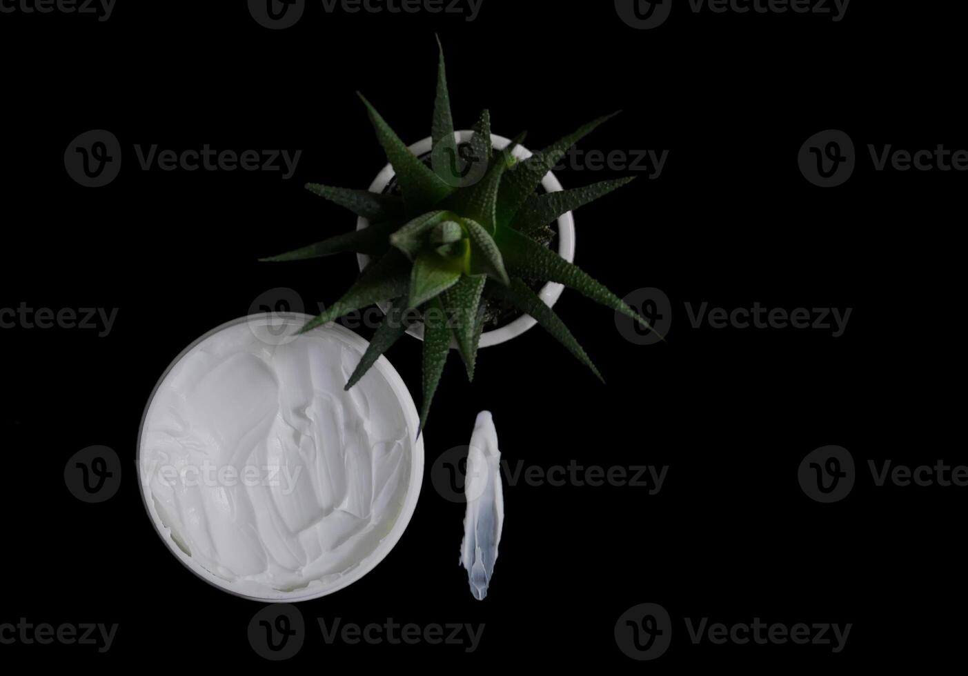 Natural organic body cream isolated on black with copy space. Cosmetics based on natural ingredients without preservatives. Concept of self-care and caring for the environment photo