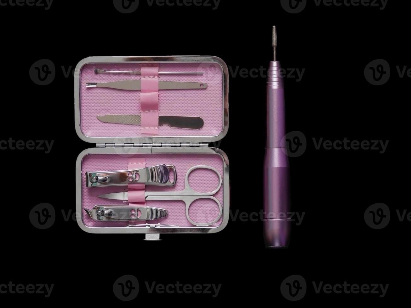 Pink manicure set isolated on black background with copy space photo