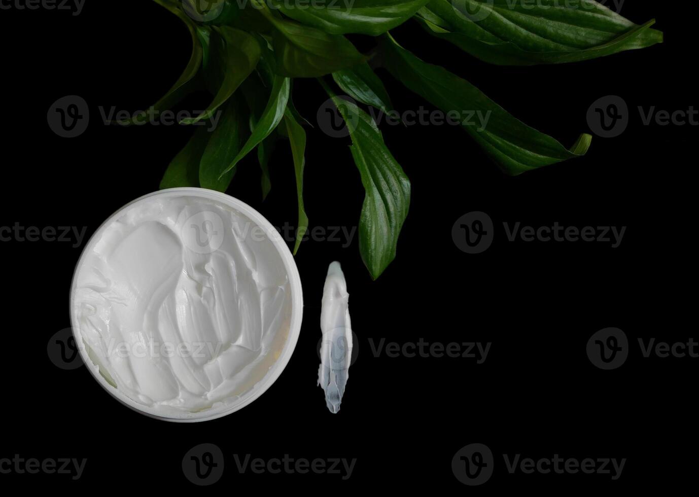 Natural organic body cream isolated on black with copy space. Cosmetics based on natural ingredients without preservatives. Concept of self-care and caring for the environment photo