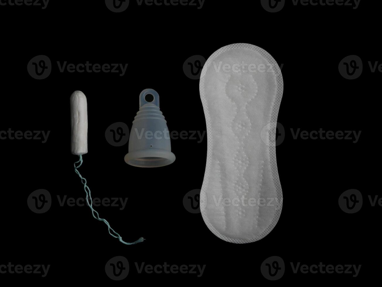 Various menstrual products - pads, tampon and menstrual cup isolated on black background. Concept of choice and comparison with copy space photo
