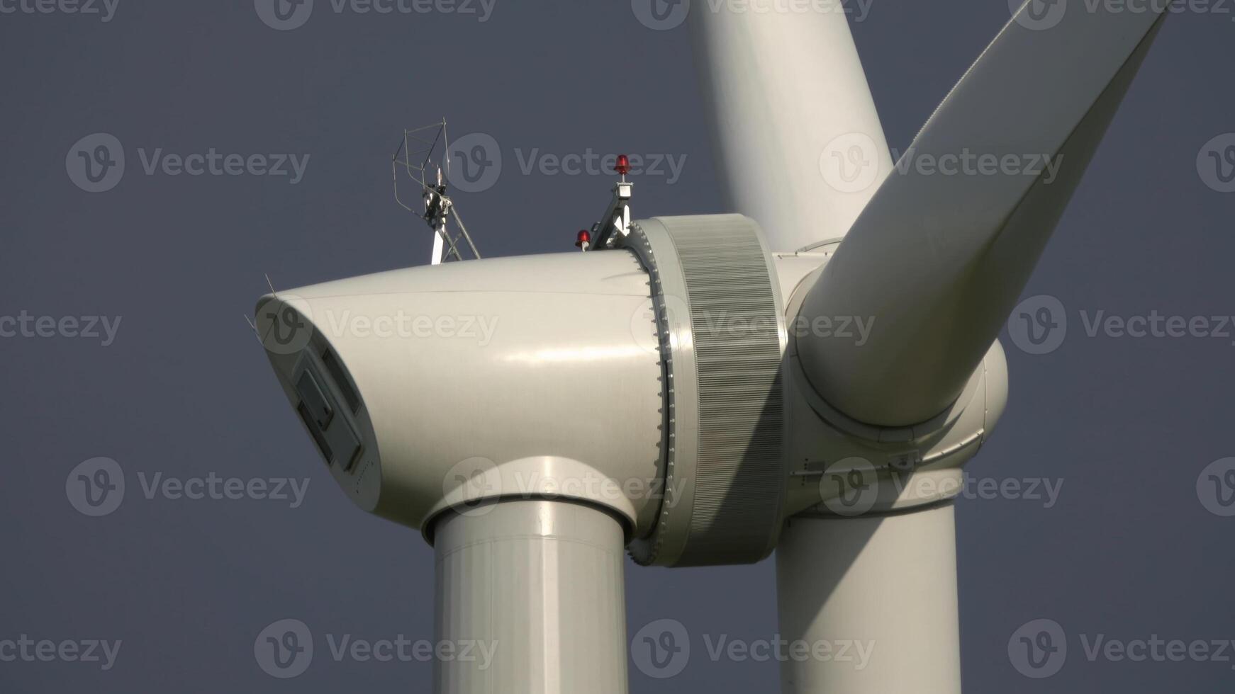 Windmill or wind turbine closeup in rotation photo
