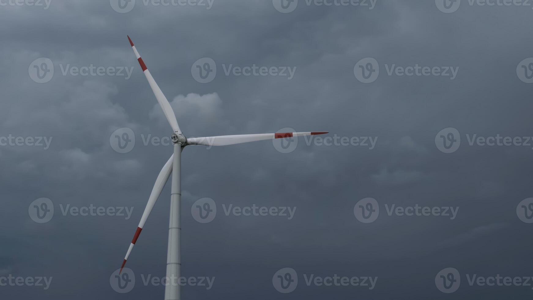 Windmill or wind turbine on wind farm in rotation photo