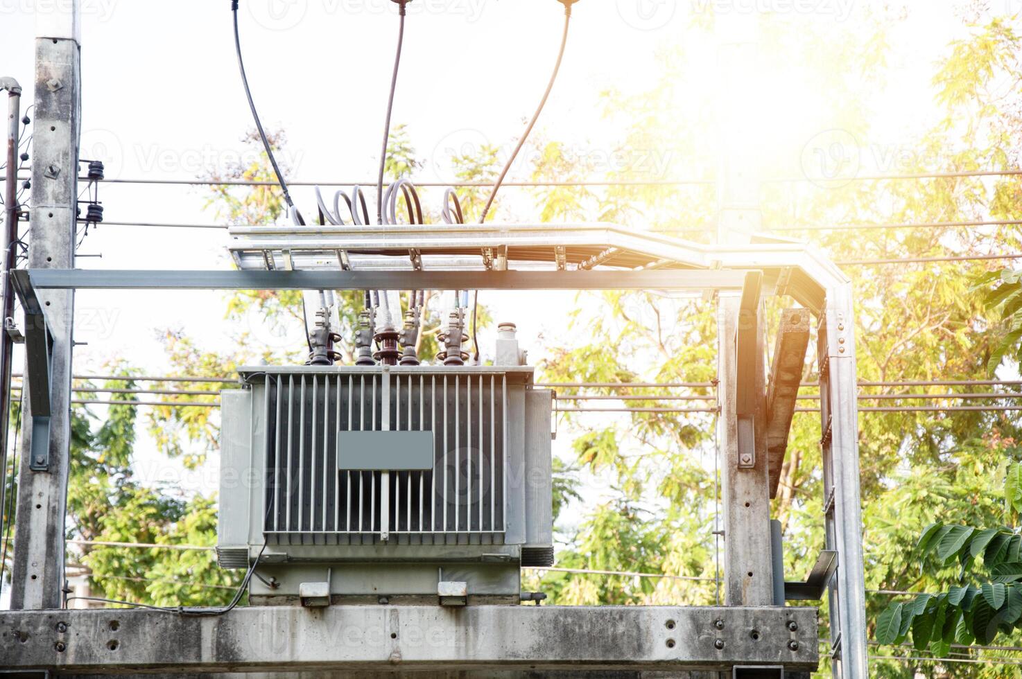 Large power transformers mounted on poles photo