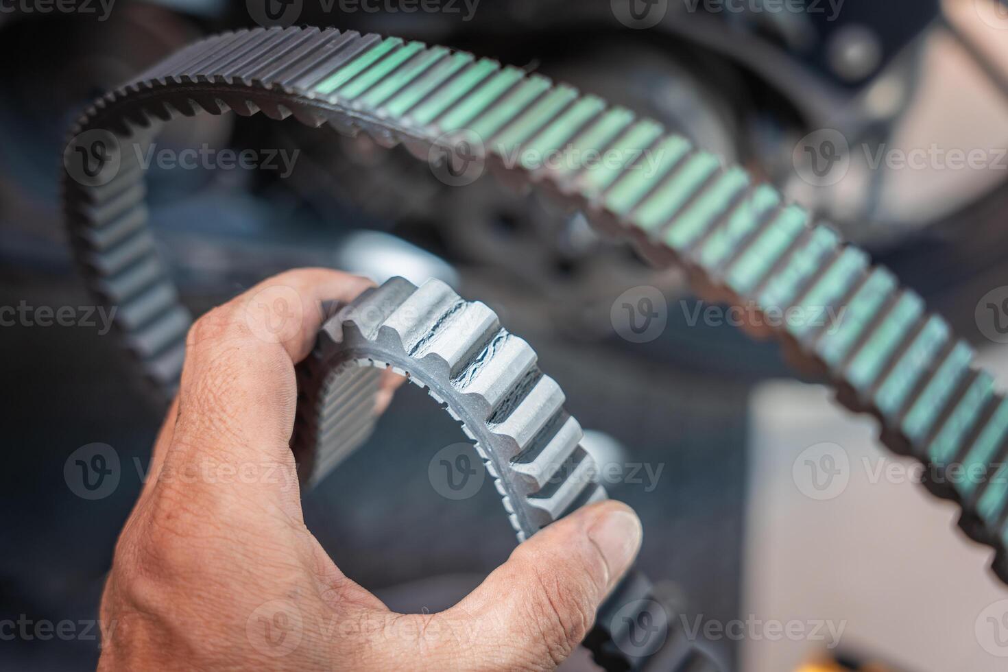 Motorcycle mechanic check the condition of motorcycle transmission belt or Drive belt ,working at garage, maintenance and repair motorcycle concept photo