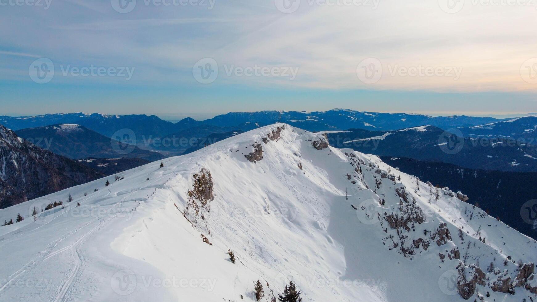 Monte Agaro mountain, part of the Lagorai chain in Trentino. Winter period at the Brocon pass. Snow-capped mountain peak. photo