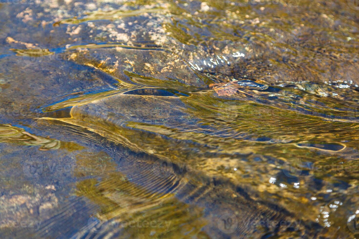flow of water and spray from a stone photo