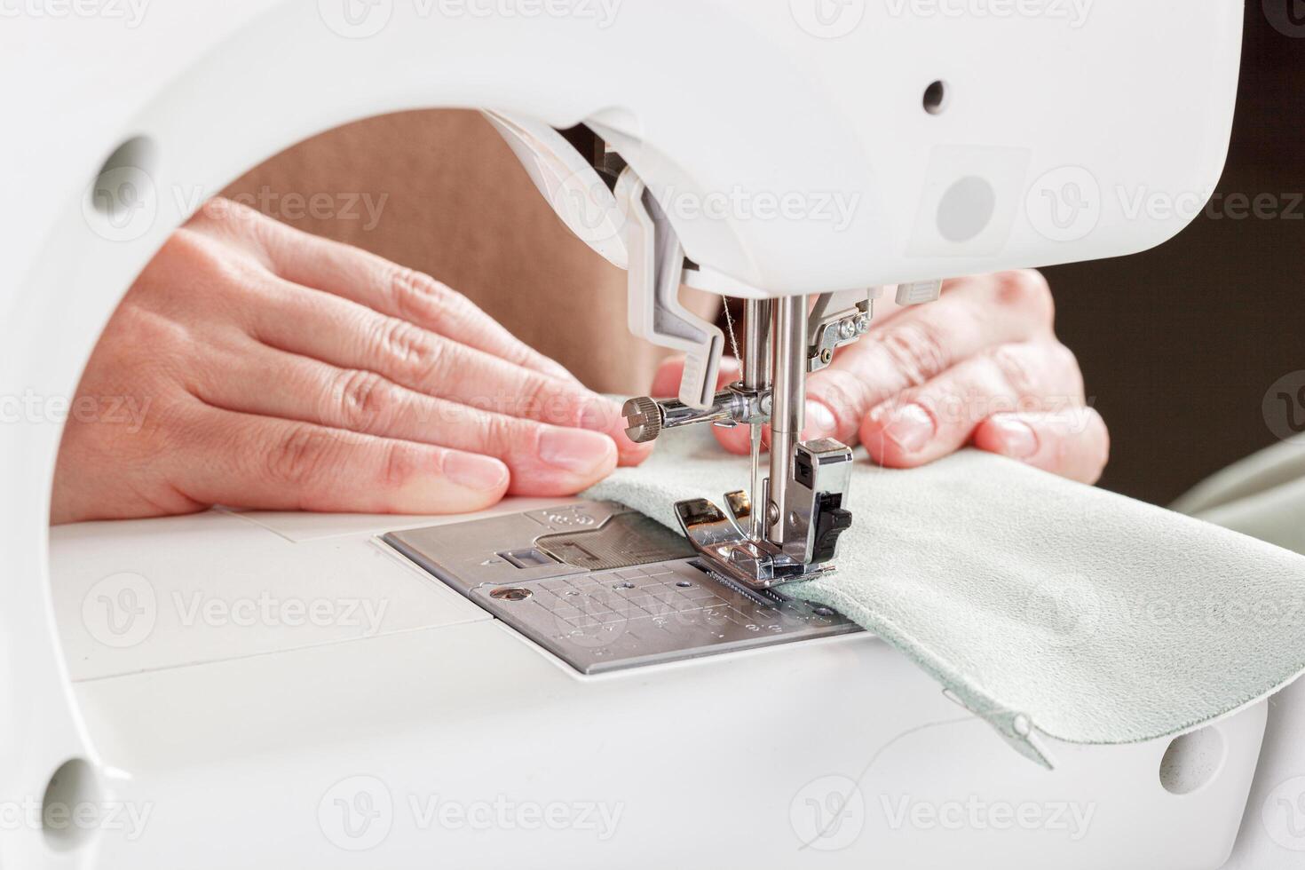 Sewing machine, stitching fabrics, needle in a round plan photo