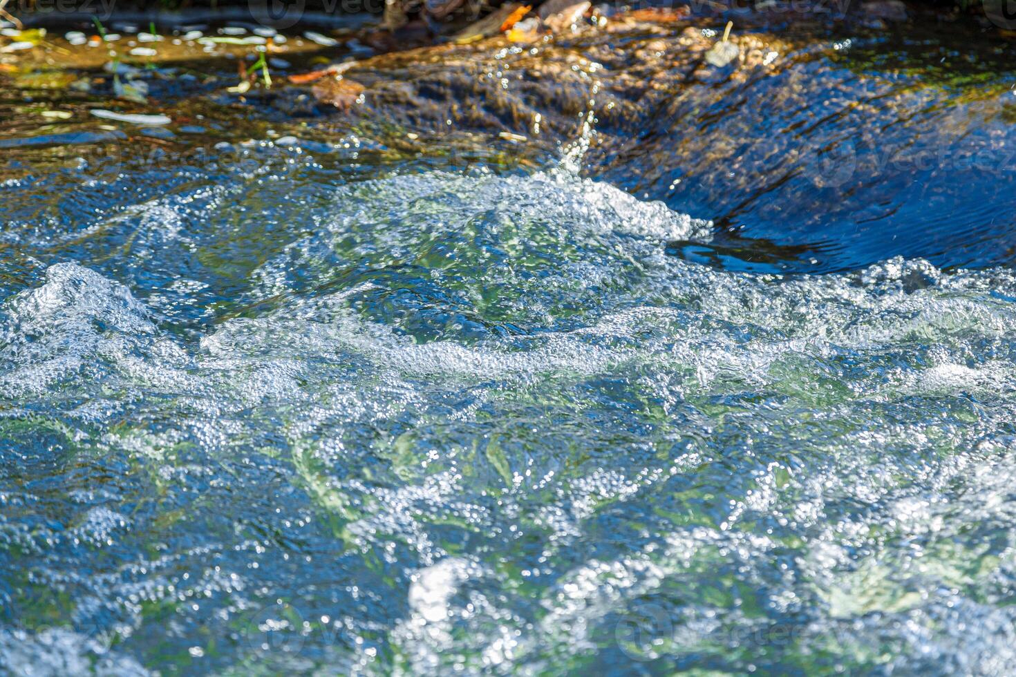 flow of water and spray from a stone photo