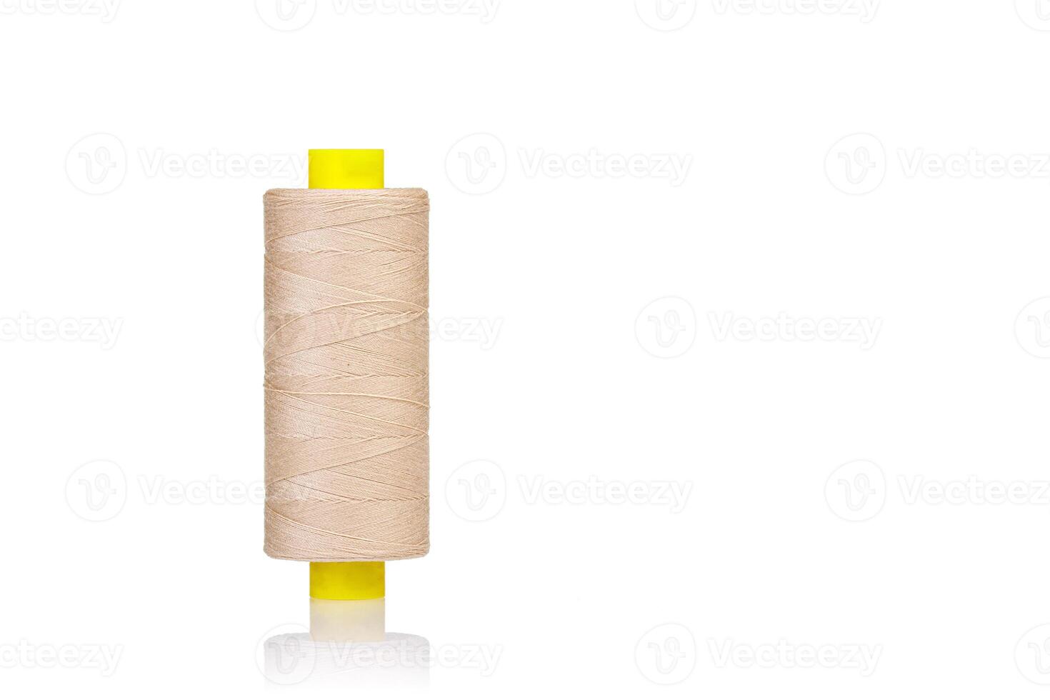 skein of beige color thread macro on a white background photo