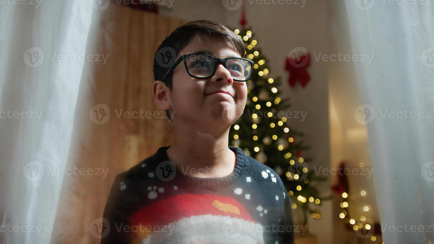 child waits for santa claus at the window photo