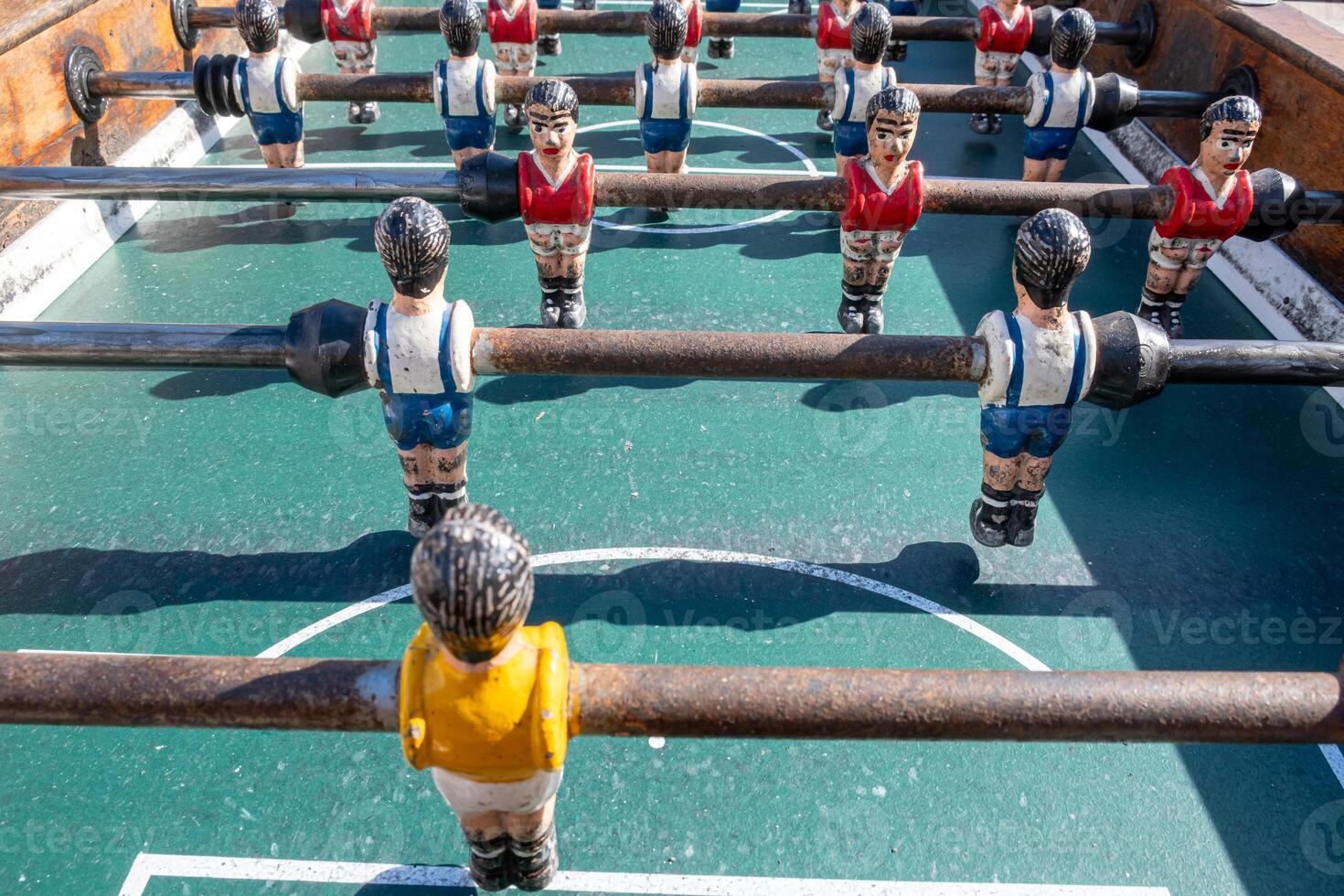 A close-up of the table football game of football figures on the field, foosball. Background for teamwork concept photo