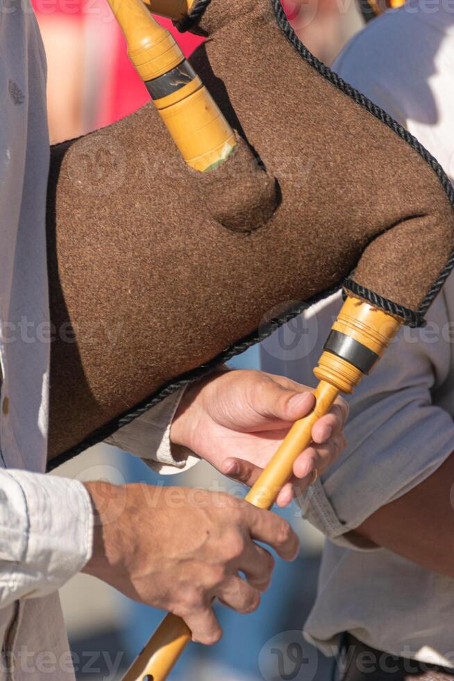 detail of the hands of a bagpipe player playing a traditional bagpipe from Portugal, background concept traditional music photo