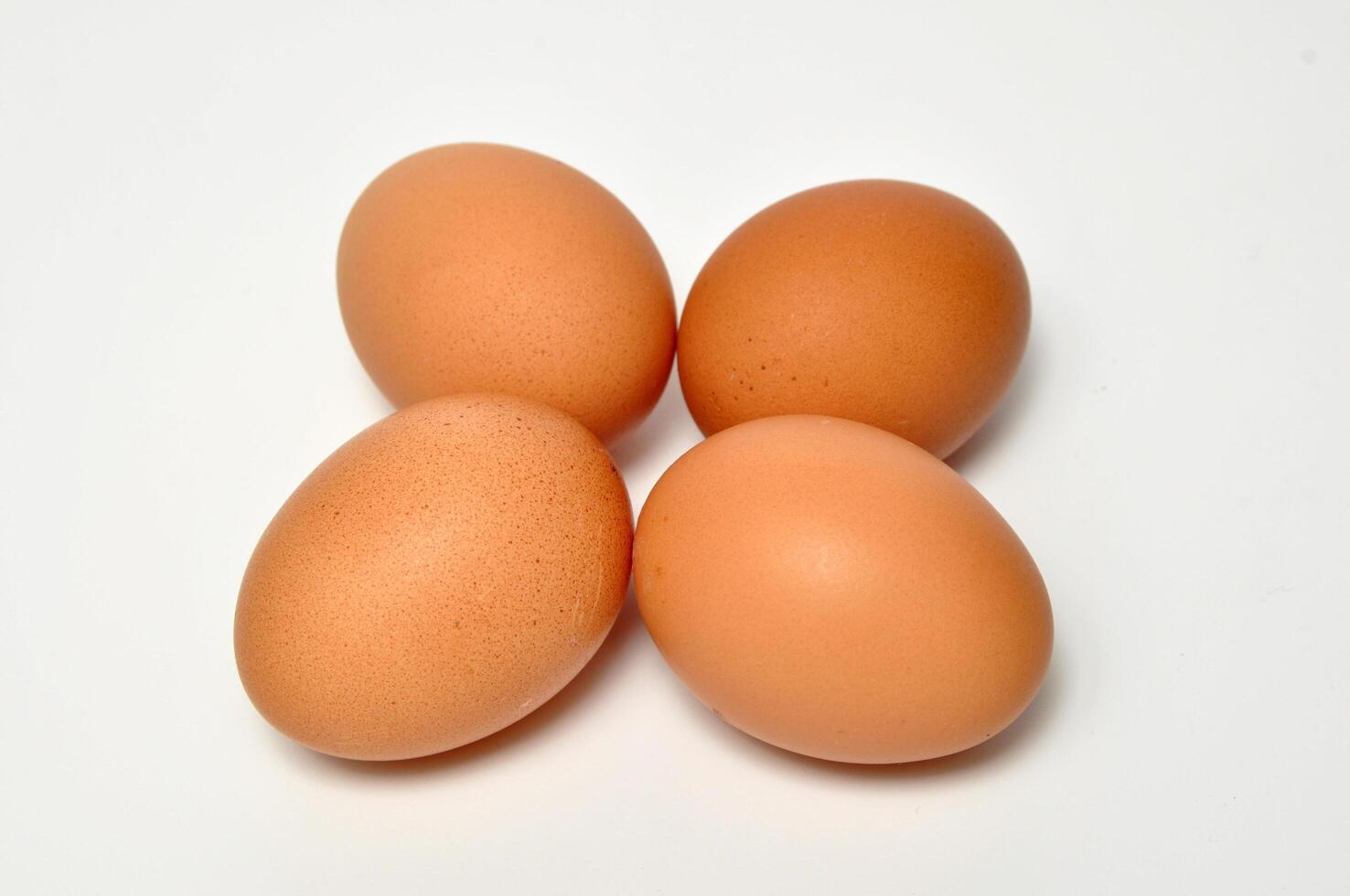 Closeup four chicken egg white background photo