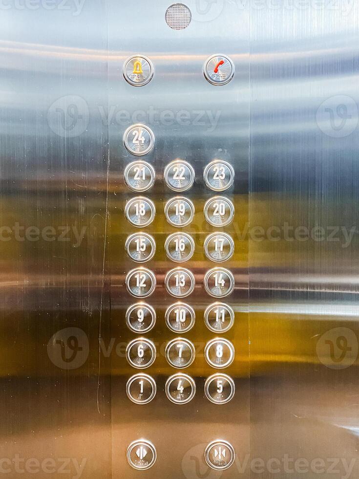 Close up of elevator panel with metallic finish and push buttons photo