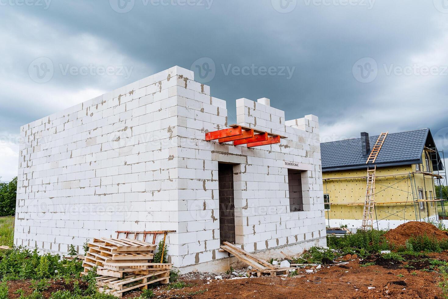 A new house is currently being constructed using white bricks photo