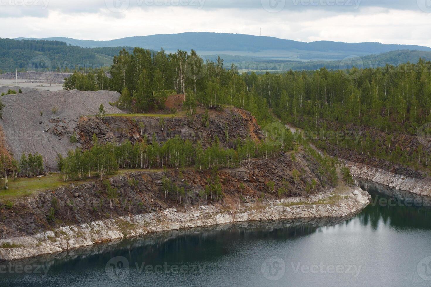 A lake nestled among lush mountains and trees viewed from above photo