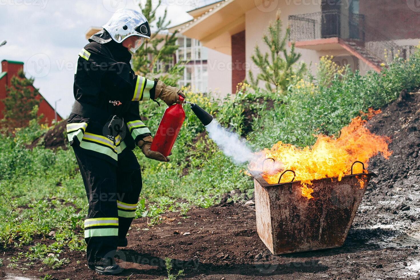 A firefighter is using a fire extinguisher to put out a fire in a building photo