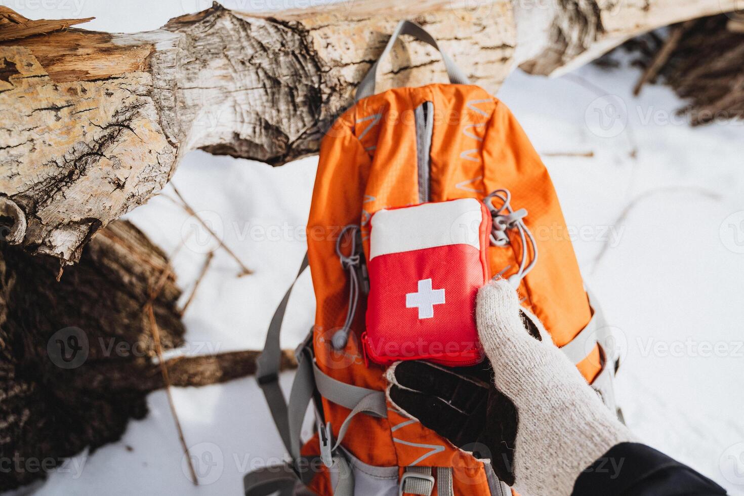 First Aid Kit in the Snow for Emergencies While Backpacking in the Wilderness photo