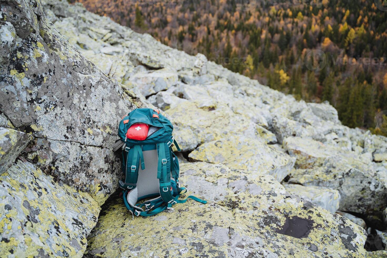 Top view of a hiking backpack with hiking equipment, a sports backpack, a first aid kit on a trip, a set for racking in the forest. photo