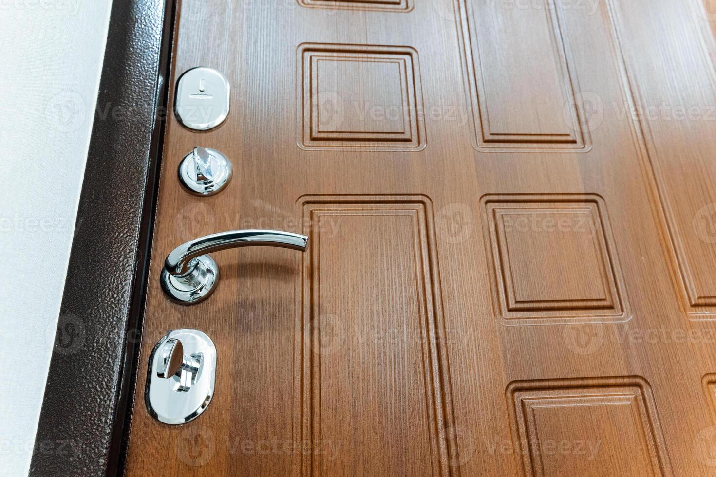 The door lock is shot close-up, chrome elements of the front door, keyhole. locking device. photo