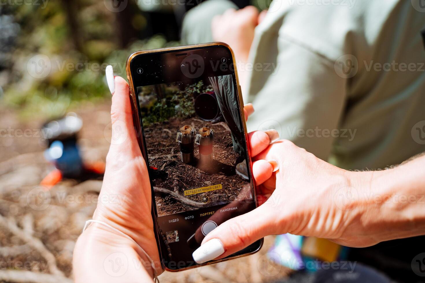 A person holding up a phone with a picture of a bird on it photo