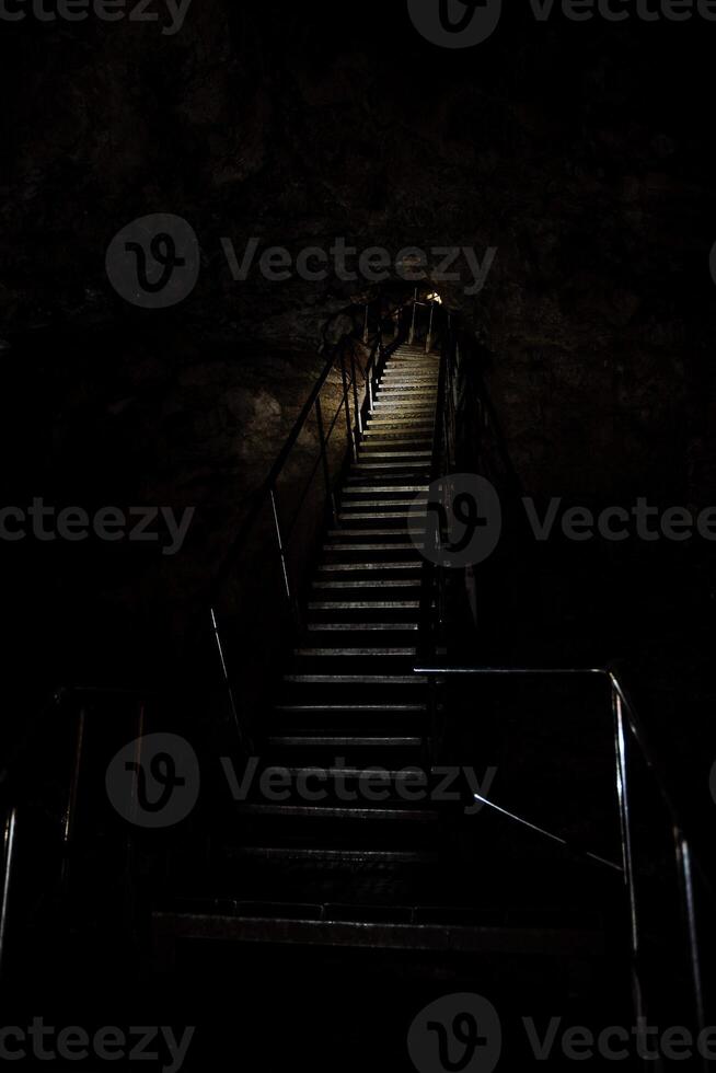 Stairs in a cave with dark lighting photo