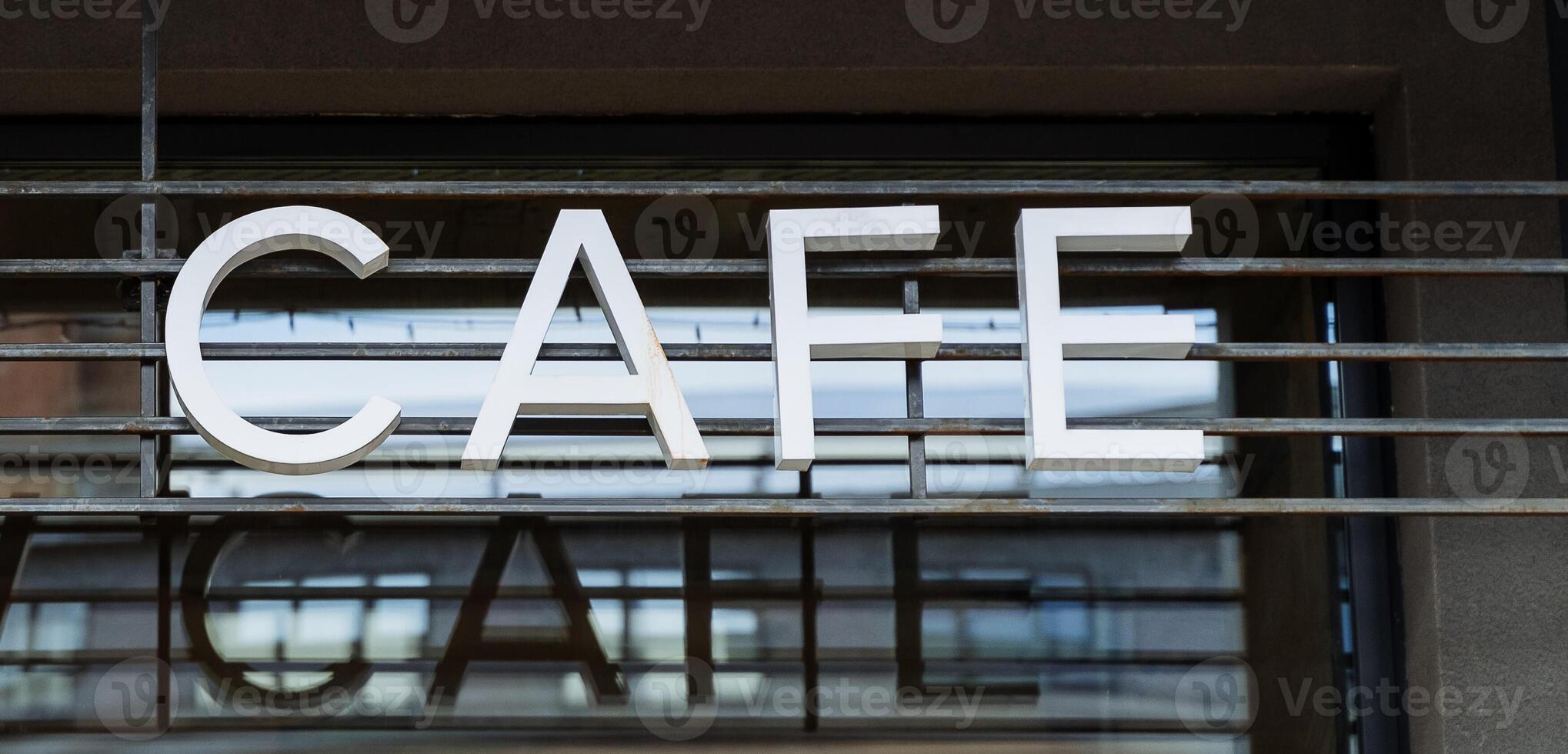 Raw cafes on the street, the sign of a vegetarian restaurant hangs on the building, advertising of oriental culture, healthy food, cafes for yogis. photo
