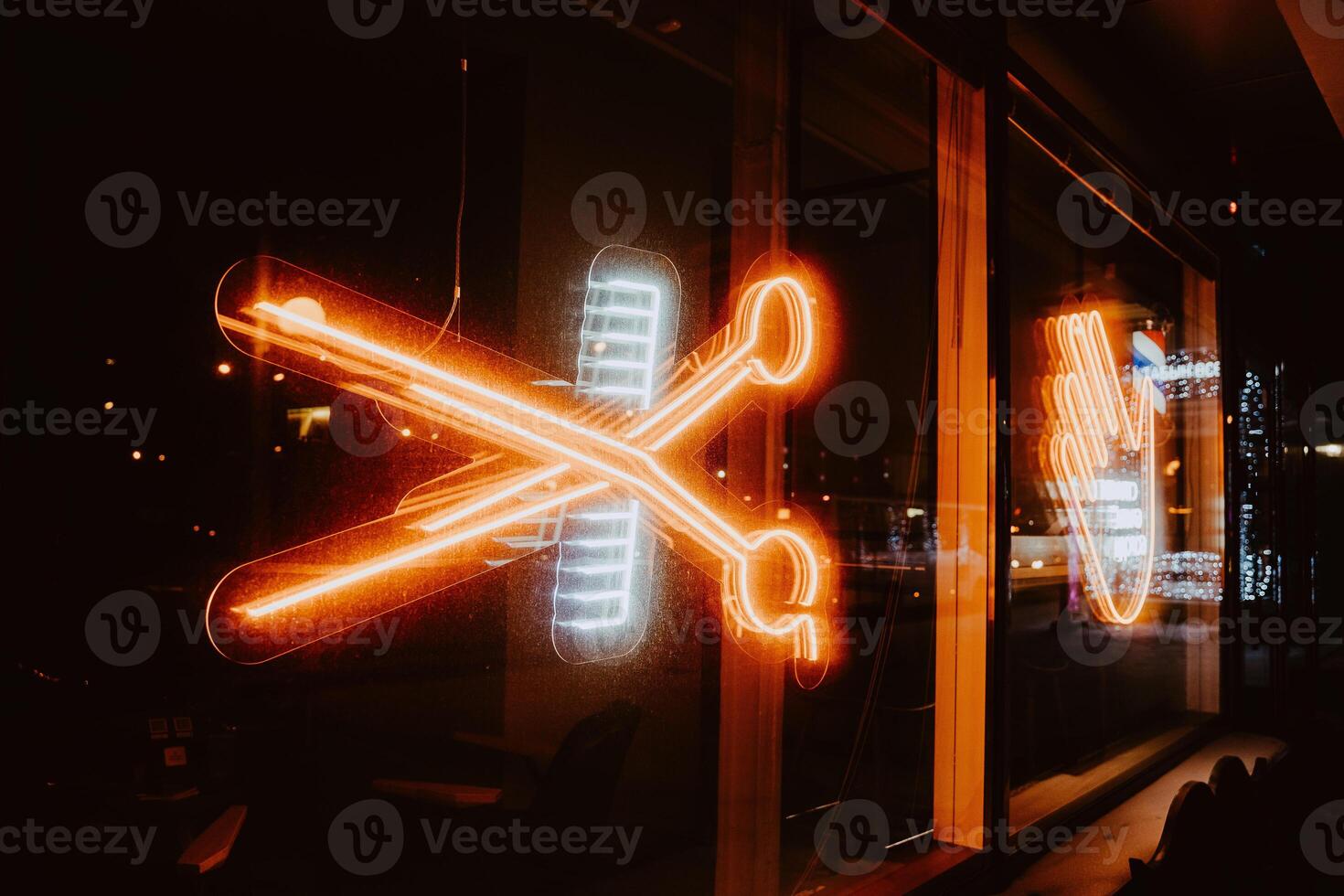 Neon sign in the form of scissors and combs. Bright and colorful photography. photo